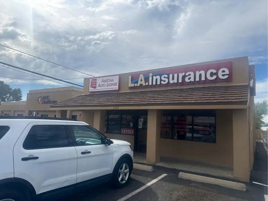 The Arizona Auto License storefront in Tucson with the red on white sign above the door.