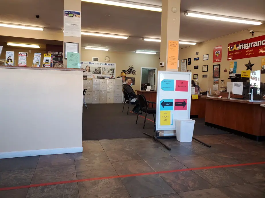 The waiting area inside the Tucson office, with seating and MVD directional signage.